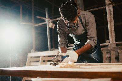 Confident wood worker expert.carpenter working at factory.