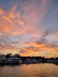Scenic view of river against sky at sunset
