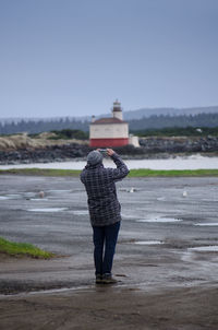 Rear view of man standing on road