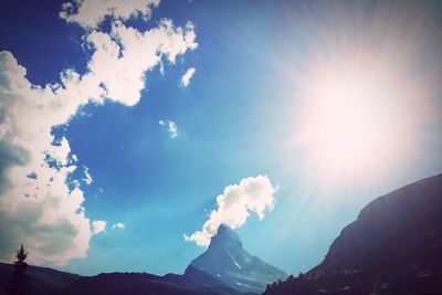 Sun shining over mountains