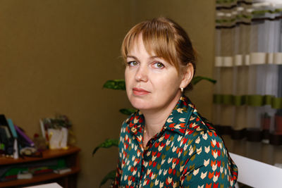 Portrait of elegant mature woman wearing blouse and looking at camera. closeup of confident woman