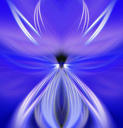 Close-up of illuminated light painting against blue background