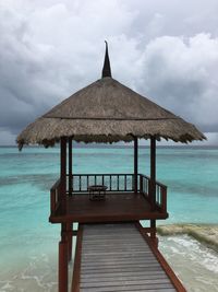 Gazebo on beach against sky