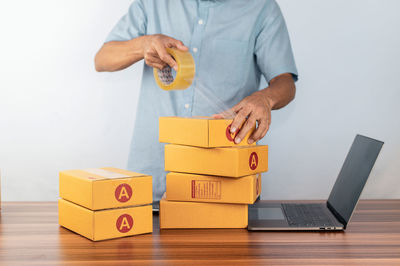 Midsection of woman holding toy blocks on table