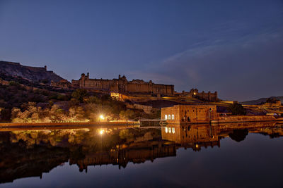 Reflection of illuminated buildings in lake at night