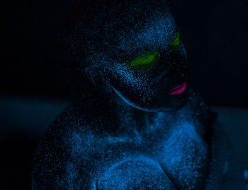 Woman with eyes closed in neon make-up