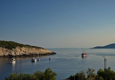 Deep bay in adriatic sea with sailboats anchored in clear blue water