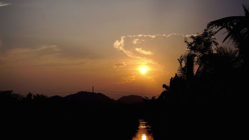 Silhouette trees against sky during sunset