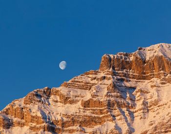 Low angle view of rock formations against blue sky