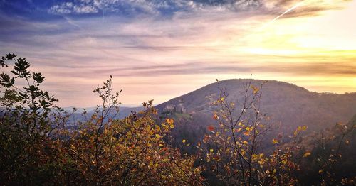 Scenic view of mountains against cloudy sky