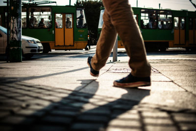 Low section view of person walking on sidewalk