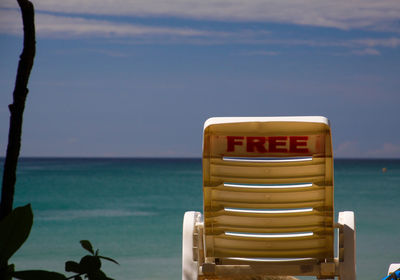 Close-up of lifeguard hut on beach against sky