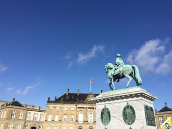 Low angle view of statue against blue sky