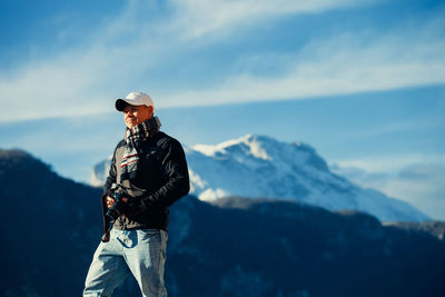 Man standing on mountain against sky