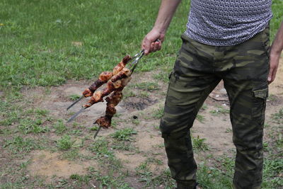 Midsection of man holding food standing outdoors