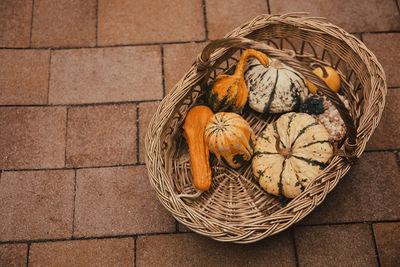 High angle view of fruits in basket on tiled floor