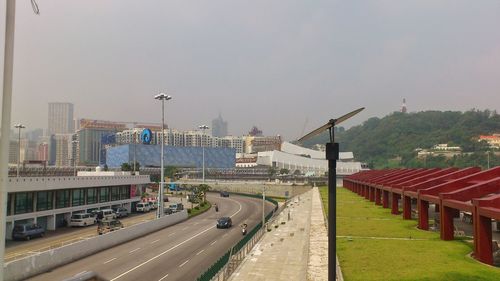 Vehicles on road against buildings in city