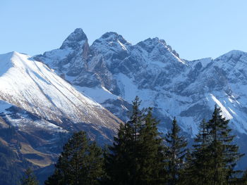 Scenic view of snowcapped mountains against clear sky