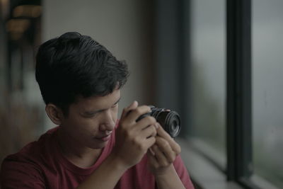 Portrait of young man photographing