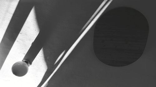 High angle view of shadow on table against wall