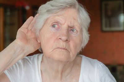 Senior woman looking away at home