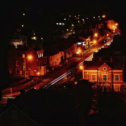 Illuminated city against sky at night