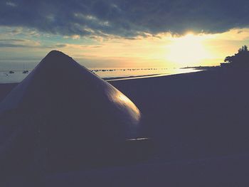 Close-up of car against sky during sunset