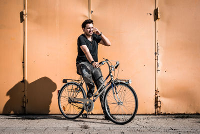 Young man sitting on bicycle
