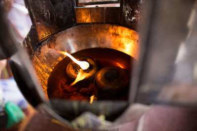 High angle view of lit oil lamp