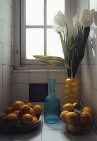 Lemons in containers on tiled floor