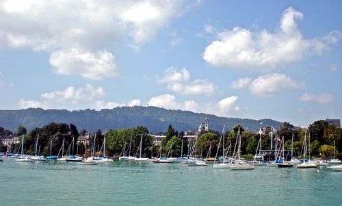 Sailboats in sea against sky