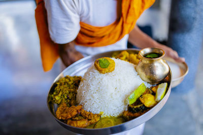 A vegetarian devotee working at the temple prepares his lunch.