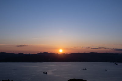 Scenic view of sea against clear sky during sunset