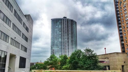 Low angle view of building against cloudy sky