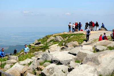 Hikers on mountain against sky at harz national park