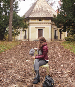 Woman sitting in front of building