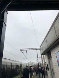 People standing in city against sky