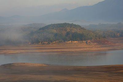 Scenic view of lake and mountains against sky