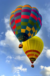 Low angle view of hot air balloons flying in sky