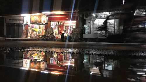 People in illuminated city at night