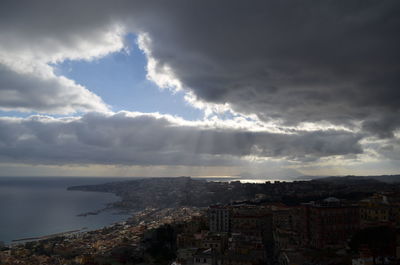 Cityscape against cloudy sky