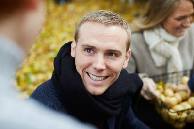 Happy man looking at boy in back yard