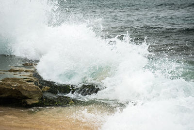 Waves breaking against sea