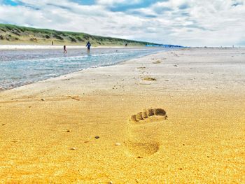 Scenic view of beach against sky