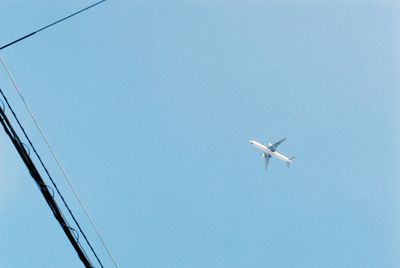 Low angle view of airplane flying in sky