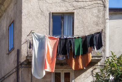 Clothes drying against wall of building