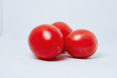 Close-up of cherry tomatoes on white background