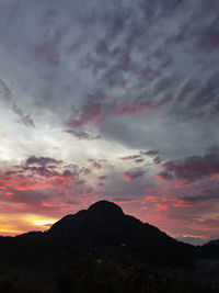 Scenic view of silhouette mountains against dramatic sky