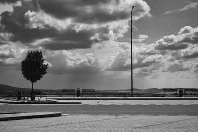 Empty road by street against sky