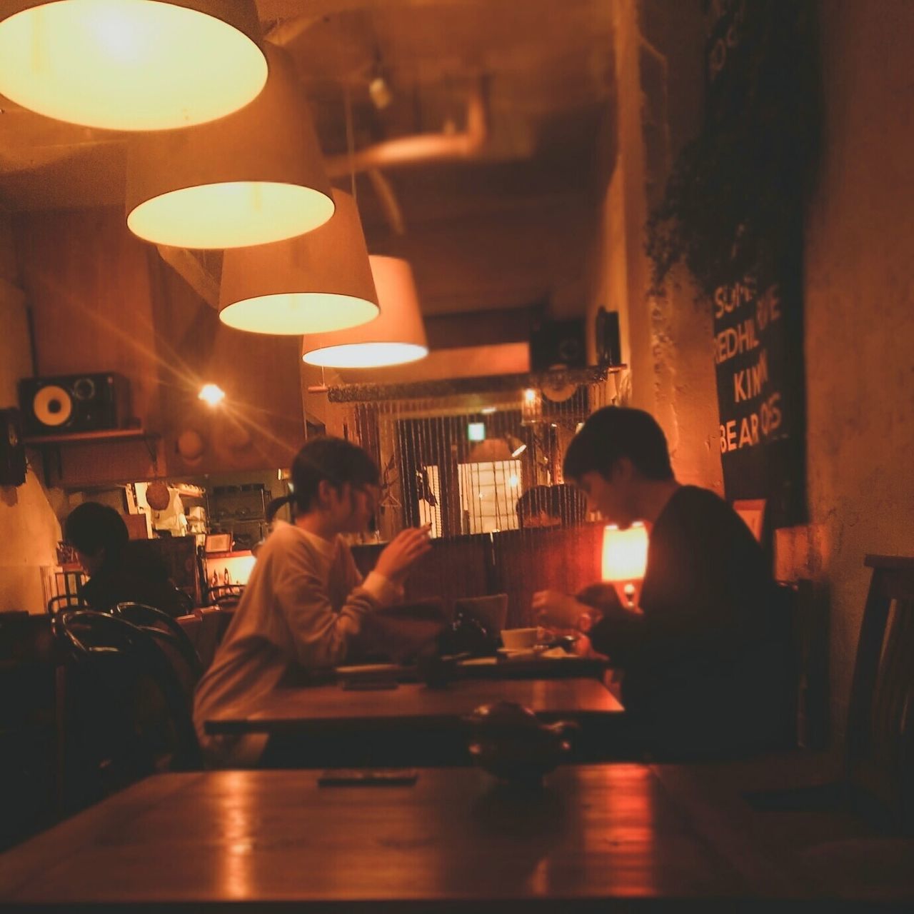 sitting, men, illuminated, restaurant, group of people, real people, lifestyles, bar - drink establishment, table, indoors, food and drink, drink, women, communication, adult, business, people, refreshment, leisure activity, bar counter, bartender, glass, happy hour